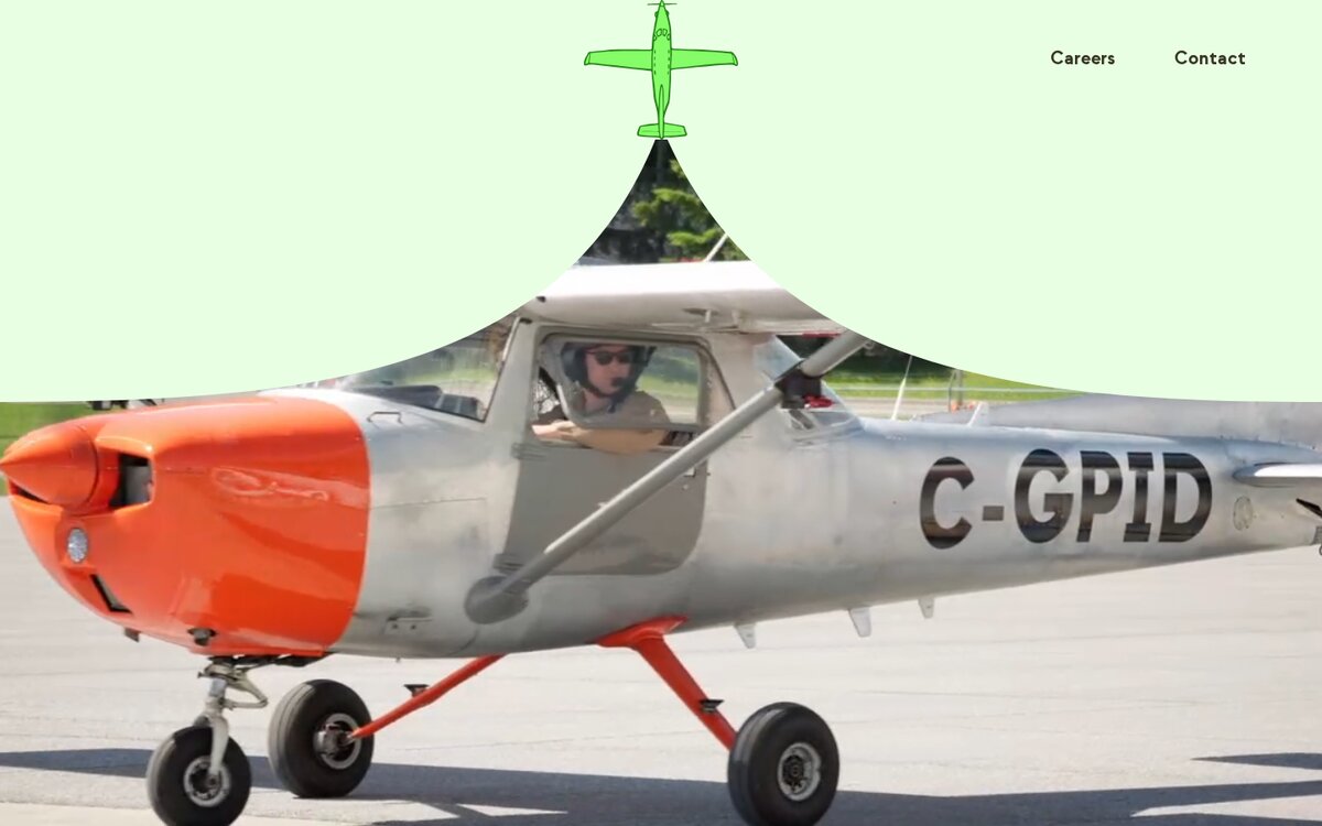The plane at the top of the page, with a photo of a Cessna on the runway opening up underneath it